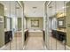 Bathroom featuring double mirrors and vanities, a tiled floor, and a luxurious tub, creating a spa-like retreat at 535 Cameron Manor Way, Atlanta, GA 30328