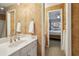 Bathroom with sink and mirror, leading to a bright bedroom, creating a seamless and elegant transition at 535 Cameron Manor Way, Atlanta, GA 30328