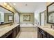 Luxurious bathroom with dual vanities, a soaking tub, and neutral tile flooring at 535 Cameron Manor Way, Atlanta, GA 30328