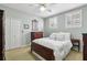 Calm bedroom with wood-frame bed and bright natural light from the two windows, creating a peaceful retreat at 535 Cameron Manor Way, Atlanta, GA 30328
