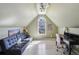 Bonus room includes a sofa, desk area, arched window, and a vaulted ceiling, providing a versatile space at 535 Cameron Manor Way, Atlanta, GA 30328