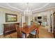 Elegant dining room with hardwood floors, chandelier, and view into the living room at 535 Cameron Manor Way, Atlanta, GA 30328