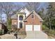 Traditional two-story brick home featuring a two-car garage and manicured front lawn at 535 Cameron Manor Way, Atlanta, GA 30328