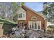 Brick home with patio and landscaped backyard, creating a cozy outdoor living space at 535 Cameron Manor Way, Atlanta, GA 30328