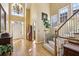 Grand foyer with hardwood floors, staircase, and high ceilings with chandelier at 535 Cameron Manor Way, Atlanta, GA 30328