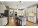 Well-appointed kitchen features an island with cooktop, stainless steel appliances and granite countertops at 535 Cameron Manor Way, Atlanta, GA 30328