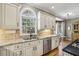 Bright kitchen with granite countertops, stainless steel appliances, and an arched window above the sink at 535 Cameron Manor Way, Atlanta, GA 30328