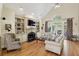 Bright living room with hardwood floors, fireplace, built-in shelving, and ample seating at 535 Cameron Manor Way, Atlanta, GA 30328