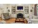 Inviting living room featuring built-in shelving, fireplace, hardwood floors, and comfortable furnishings at 535 Cameron Manor Way, Atlanta, GA 30328