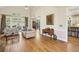 Bright living room with hardwood floors, large windows, and open access to kitchen and dining areas at 535 Cameron Manor Way, Atlanta, GA 30328