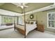 Spacious bedroom featuring a tray ceiling, carpeted floors, and large windows at 535 Cameron Manor Way, Atlanta, GA 30328