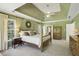 The main bedroom suite features a tray ceiling and neutral carpet at 535 Cameron Manor Way, Atlanta, GA 30328