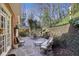 Inviting backyard patio with stone and comfortable seating with beautiful greenery for outdoor gatherings at 535 Cameron Manor Way, Atlanta, GA 30328