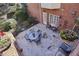 Home's stone patio is perfect for dining alfresco, featuring cozy seating and potted plants, ideal for relaxation at 535 Cameron Manor Way, Atlanta, GA 30328