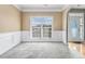 Formal dining room features wainscoting, neutral tones, and natural light at 9005 Aldbury Dr, Locust Grove, GA 30248