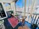 Cozy screened-in balcony with wicker furniture and sheer curtains for privacy at 1445 Monroe Ne Dr # G3, Atlanta, GA 30324