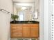 Well-lit bathroom featuring granite counters, wooden cabinets, and ample mirror space at 1445 Monroe Ne Dr # G3, Atlanta, GA 30324