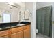 Bathroom featuring granite counters, wooden cabinets, and a shower with curtain at 1445 Monroe Ne Dr # G3, Atlanta, GA 30324