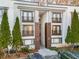 Attractive exterior with two-story units, brown accents, and mature evergreens for enhanced curb appeal at 1445 Monroe Ne Dr # G3, Atlanta, GA 30324