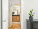 Hallway view leading to a bathroom with wooden floors and natural light at 1445 Monroe Ne Dr # G3, Atlanta, GA 30324