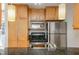 Modern kitchen with stainless steel appliances, granite countertops, and wood cabinets at 1445 Monroe Ne Dr # G3, Atlanta, GA 30324