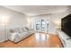 Bright living room features hardwood floors and sliding glass doors to the outdoor balcony area at 1445 Monroe Ne Dr # G3, Atlanta, GA 30324