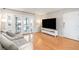 Bright and open living room featuring a plush couch, hardwood floors, and glass door access to balcony at 1445 Monroe Ne Dr # G3, Atlanta, GA 30324