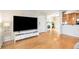 Spacious living room with hardwood floors, a fireplace, and a large TV on a sleek stand at 1445 Monroe Ne Dr # G3, Atlanta, GA 30324