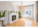 Cozy living space featuring a fireplace, window view, and hardwood floors with natural light at 1445 Monroe Ne Dr # G3, Atlanta, GA 30324