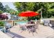 Resort-style pool area with umbrella-covered table and chairs, grill and lush landscaping at 1445 Monroe Ne Dr # G3, Atlanta, GA 30324