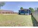 Spacious backyard featuring a large grassy area, a private fence, and ample space for outdoor activities at 1497 Rogers Sw Ave, Atlanta, GA 30310
