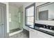 Bathroom featuring a granite countertop, white vanity, glass-enclosed shower, and neutral paint at 1497 Rogers Sw Ave, Atlanta, GA 30310