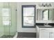 Contemporary bathroom featuring a glass shower, granite vanity, stylish mirror, and a tiled floor at 1497 Rogers Sw Ave, Atlanta, GA 30310