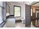 Well-lit bathroom with a glass shower, granite vanity, toilet, and open view to the hallway at 1497 Rogers Sw Ave, Atlanta, GA 30310