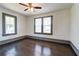 Bedroom with hardwood floors, modern ceiling fan, and two windows offering natural light at 1497 Rogers Sw Ave, Atlanta, GA 30310