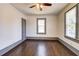 Sunny bedroom with hardwood floors, ceiling fan, and a large window overlooking the outdoors at 1497 Rogers Sw Ave, Atlanta, GA 30310