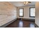 Cozy bedroom with hardwood floors, shiplap accent wall, and a modern ceiling fan at 1497 Rogers Sw Ave, Atlanta, GA 30310