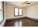 This bedroom features wooden floors, white walls, modern windows, and a ceiling fan at 1497 Rogers Sw Ave, Atlanta, GA 30310