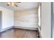 This bedroom features wooden floors, a ceiling fan, and a rustic wood accent wall at 1497 Rogers Sw Ave, Atlanta, GA 30310