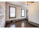 This bedroom features wooden floors, modern windows, and a rustic wood accent wall at 1497 Rogers Sw Ave, Atlanta, GA 30310