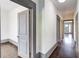 Hallway with wood floors, painted trim, and multiple doorways offering a view through the home at 1497 Rogers Sw Ave, Atlanta, GA 30310