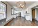 Bright kitchen featuring stainless steel appliances, white cabinetry, granite countertops, and hardwood floors at 1497 Rogers Sw Ave, Atlanta, GA 30310