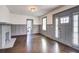 Living room featuring a fireplace, gray trim, hardwood floors, and a paneled wall at 1497 Rogers Sw Ave, Atlanta, GA 30310
