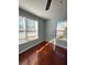 Bright bedroom featuring hardwood floors and ample natural light from large windows at 3426 Glenwood Rd, Decatur, GA 30032