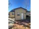 Exterior view of the home featuring beige siding, brick patio and white door at 3426 Glenwood Rd, Decatur, GA 30032