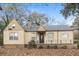 Charming single-story home with a small porch, traditional windows, and manicured landscaping at 3426 Glenwood Rd, Decatur, GA 30032