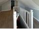Hallway with white railing and carpeted floor with door in the back at 3426 Glenwood Rd, Decatur, GA 30032