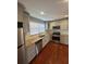This updated kitchen features stainless steel appliances, light gray cabinets, and granite countertops at 3426 Glenwood Rd, Decatur, GA 30032