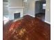 Inviting living room with hardwood floors, a brick fireplace, and built-in shelving at 3426 Glenwood Rd, Decatur, GA 30032