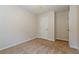 A simple bedroom featuring neutral carpeting, paint and a white door at 8409 Carlington Ln, Jonesboro, GA 30236